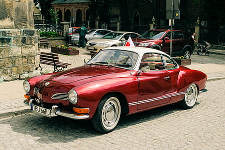 red coupe on grey road thumbnail