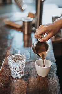 person putting brown liquid to the teacup thumbnail