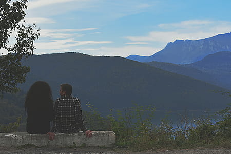 Man and Woman Sitting on Rock thumbnail