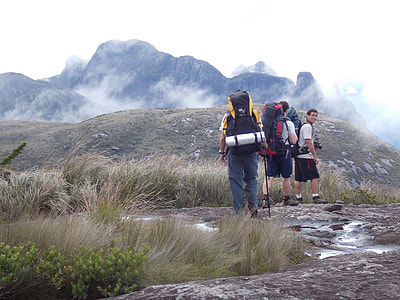 three men walking on mountain at daytime thumbnail