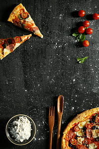 two slice of pizza near tomatoes and spoon thumbnail
