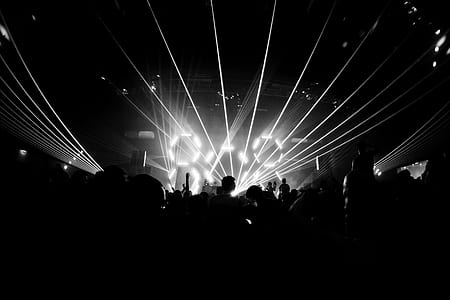 grayscale photography of concert with lights thumbnail