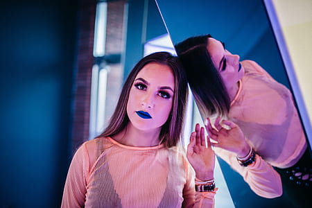 woman wearing blue lipstick with mirror reflection thumbnail