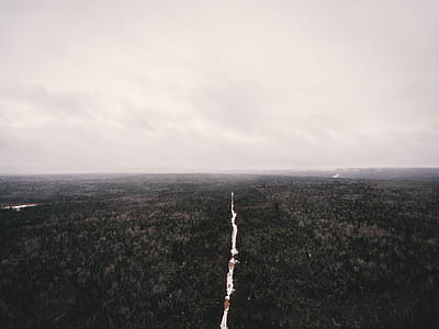 aerial photography of body of water in middle of forest during day thumbnail