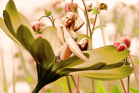 woman in gray halter dress sitting on flower during daytime thumbnail