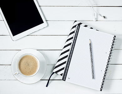 White Tablet Computer Beside White Notebook thumbnail