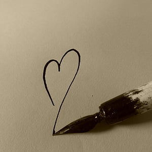black and white paint brush draws heart on paper thumbnail