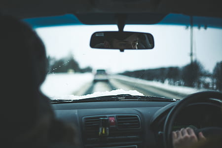 person driving left handed vehicle on road thumbnail