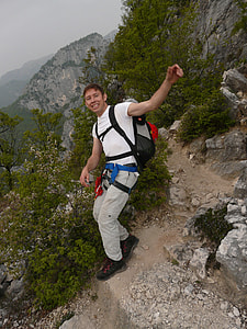 man standing on rock cliff at daytime thumbnail