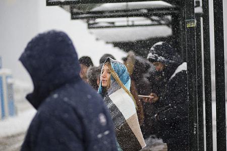 shallow focus photography of woman standing beside black post thumbnail