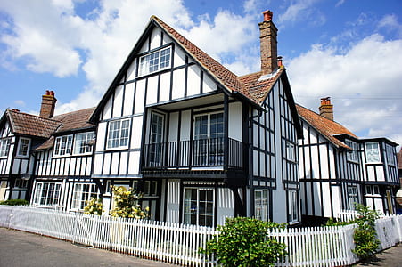 white, brown, and black painted house thumbnail