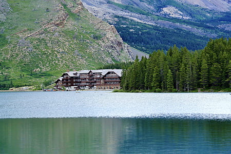 house near mountains and body of water thumbnail