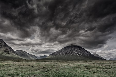 landscape photography of mountain near green grass field thumbnail