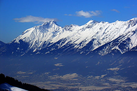 snow-covered mountains under blue sky thumbnail