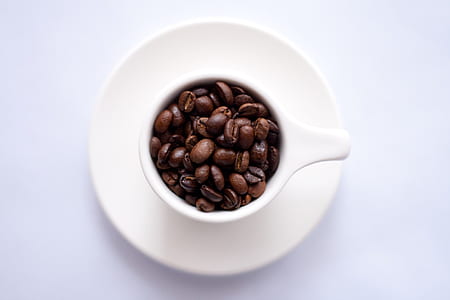 coffee beans on white ceramic mug and saucer thumbnail