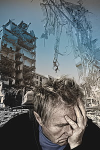 man wearing black hoodie holding face with wrecked building background thumbnail