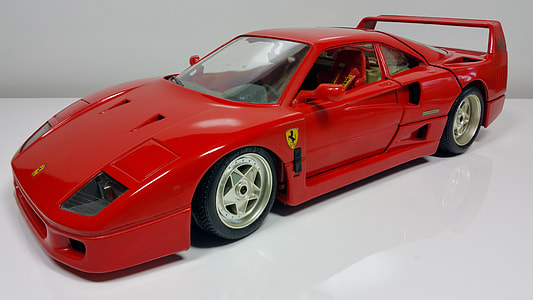 red Ferrari car die-cast model on white surface thumbnail