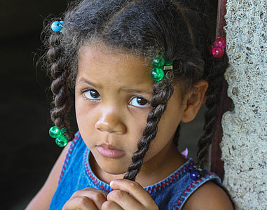 girl holding hair near the gray wall thumbnail