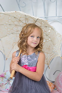 girl wearing gray sequin sleeveless dress holding beige umbrella thumbnail