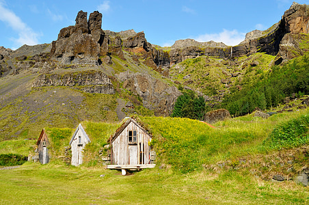 three house near hill at daytime thumbnail