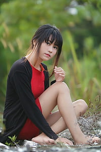 woman sitting on water wearing blac cardigan thumbnail