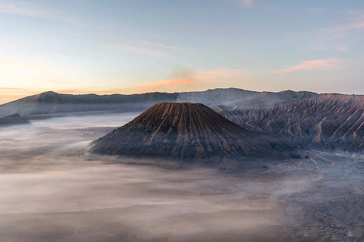 brown mountain under blue cloudy sky