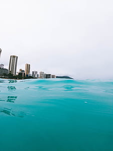 body of water near buildings at daytime thumbnail