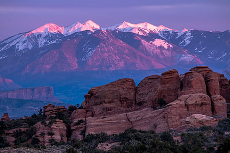 brown rock formation near mountain during daytime thumbnail