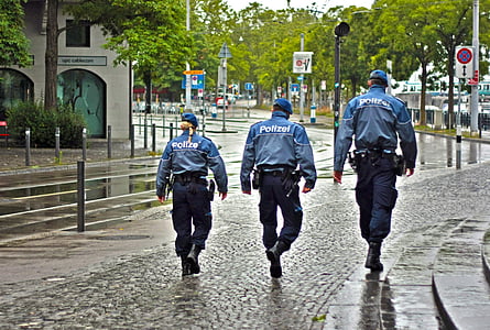 three Police officers walking on black road thumbnail