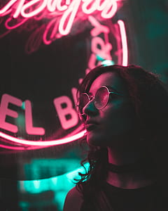 woman standing near the red neon light during night time thumbnail