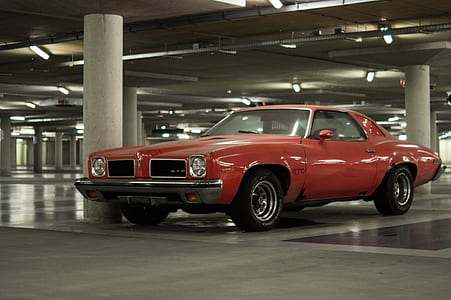 red Pontiac GTO coupe on garage thumbnail