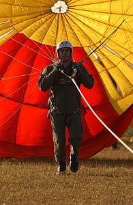 man wearing black overall pants and white half helmet using parachute thumbnail