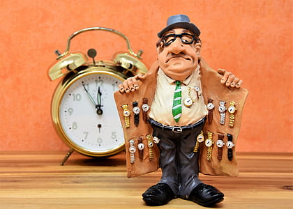 man showing watch on his coat figurine thumbnail