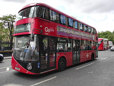 red double decker bus on street thumbnail