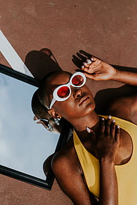 woman wearing white-frame sunglasses and yellow swimsuit thumbnail