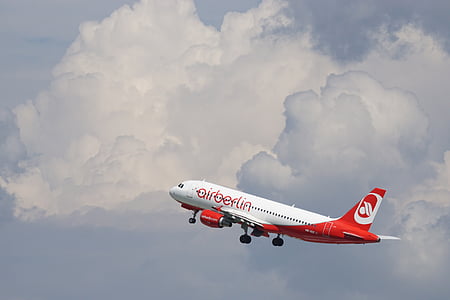whtie and red Airberlin airplane flying midair under white clouds at daytime thumbnail