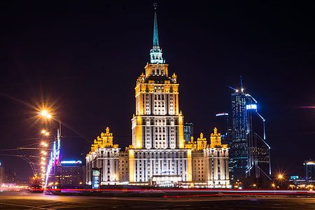 beige and black concrete buildings turned on lights during night time thumbnail