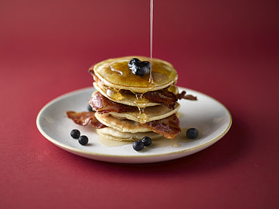 pancake stuffed with bacon and syrup filling on plate thumbnail