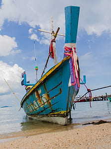 docked blue boat thumbnail