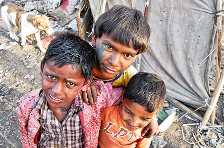 three boys standing close to each other thumbnail