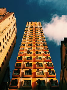 low-angle photography of orange high rise building thumbnail