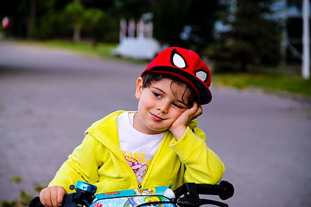 boy wearing yellow zip-up jacket and spiderman cap thumbnail