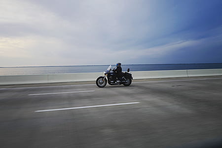 person riding on touring motorcycle on road thumbnail