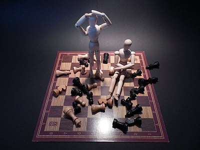two puppets on chess board thumbnail