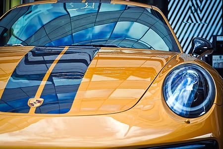 gold-colored Porsche Cayman coupe thumbnail
