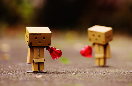 selective focus photography of box girl holding heart thumbnail