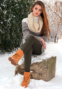 sitting woman wearing white knit cowl and brown work boots thumbnail