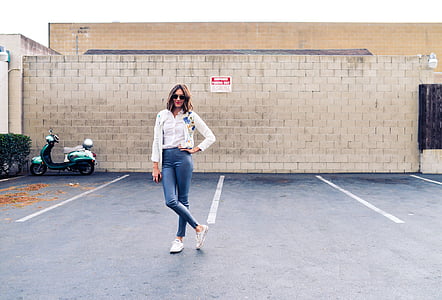 woman standing near brick wall thumbnail