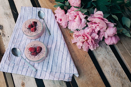 two dessert cups beside spoons thumbnail
