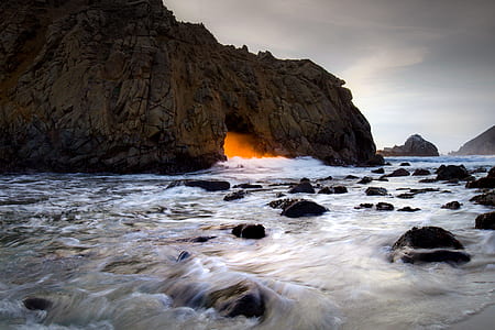 view of cave on body of water thumbnail